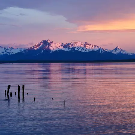 Catch the colours of sunrise over the Puerto Natales coastline