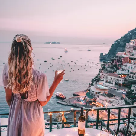 Young woman with blonde hair on balcony in Positano Italy