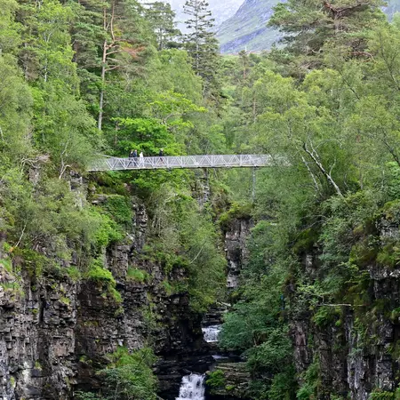 Suspension bridge over the gorge at the Falls Of Measach waterfall near Braemore, Highland, Scotland