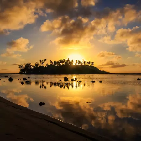 Island at sunrise on muri beach in Cook Islands