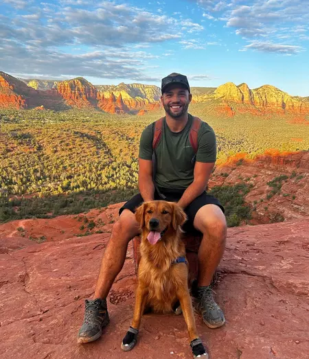 Greg Chabursky posing with his dog.