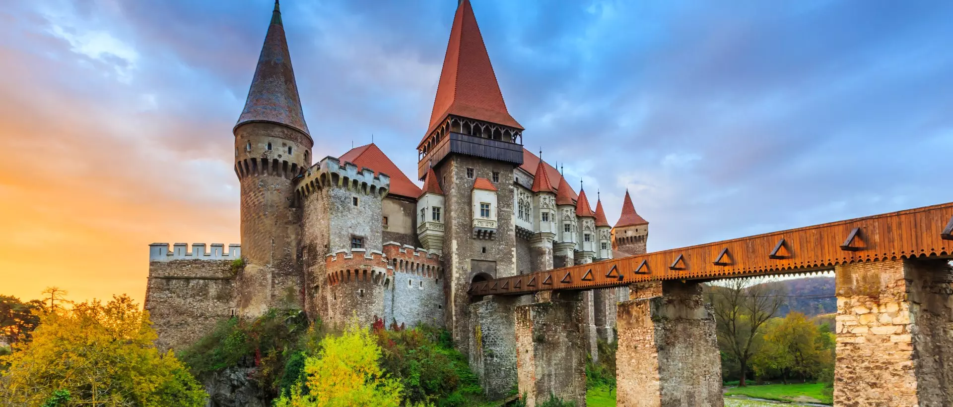 a medieval castle with a bridge over a river.