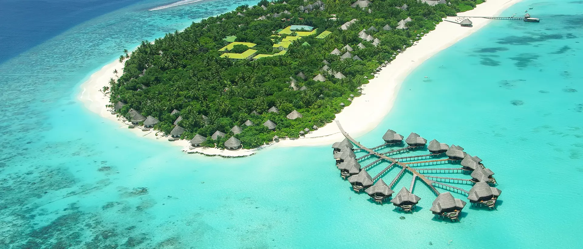 aerial view of overwater bungalows and white-sand beach island