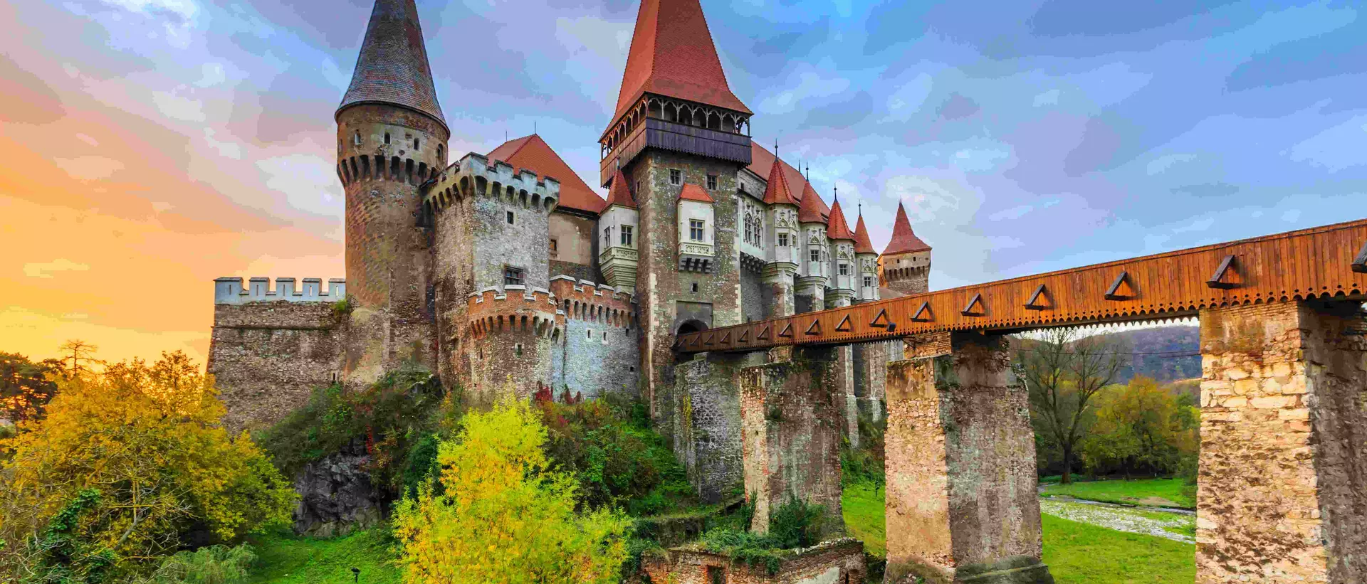 a medieval castle with a bridge over a river