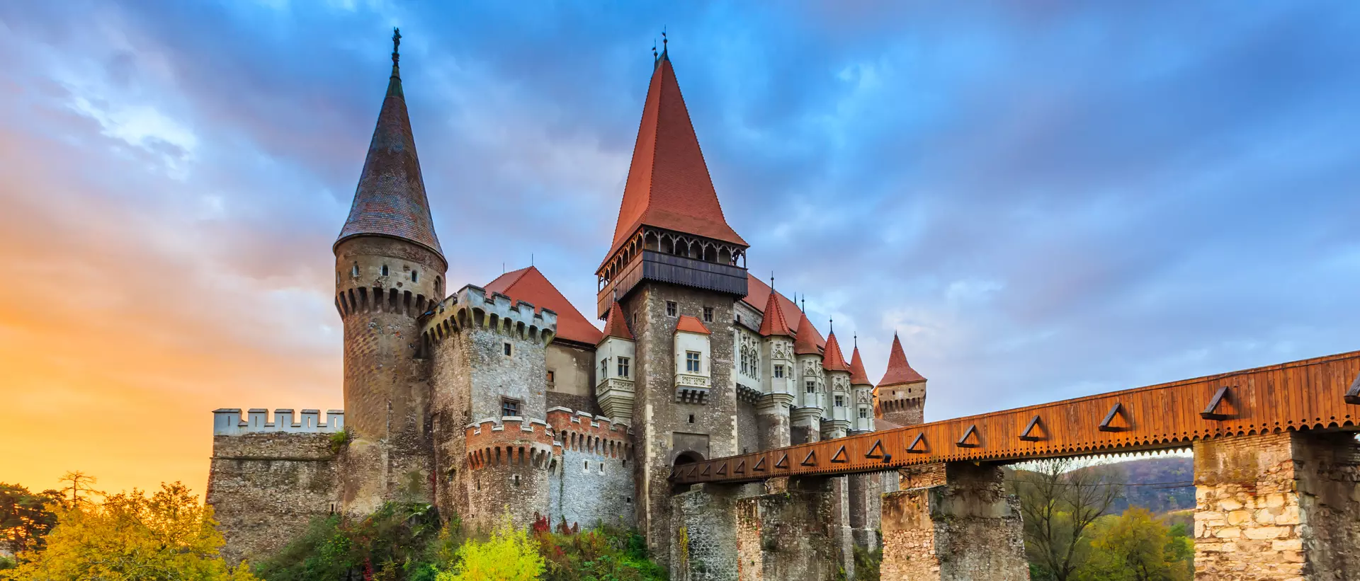 a medieval castle with a bridge over a river