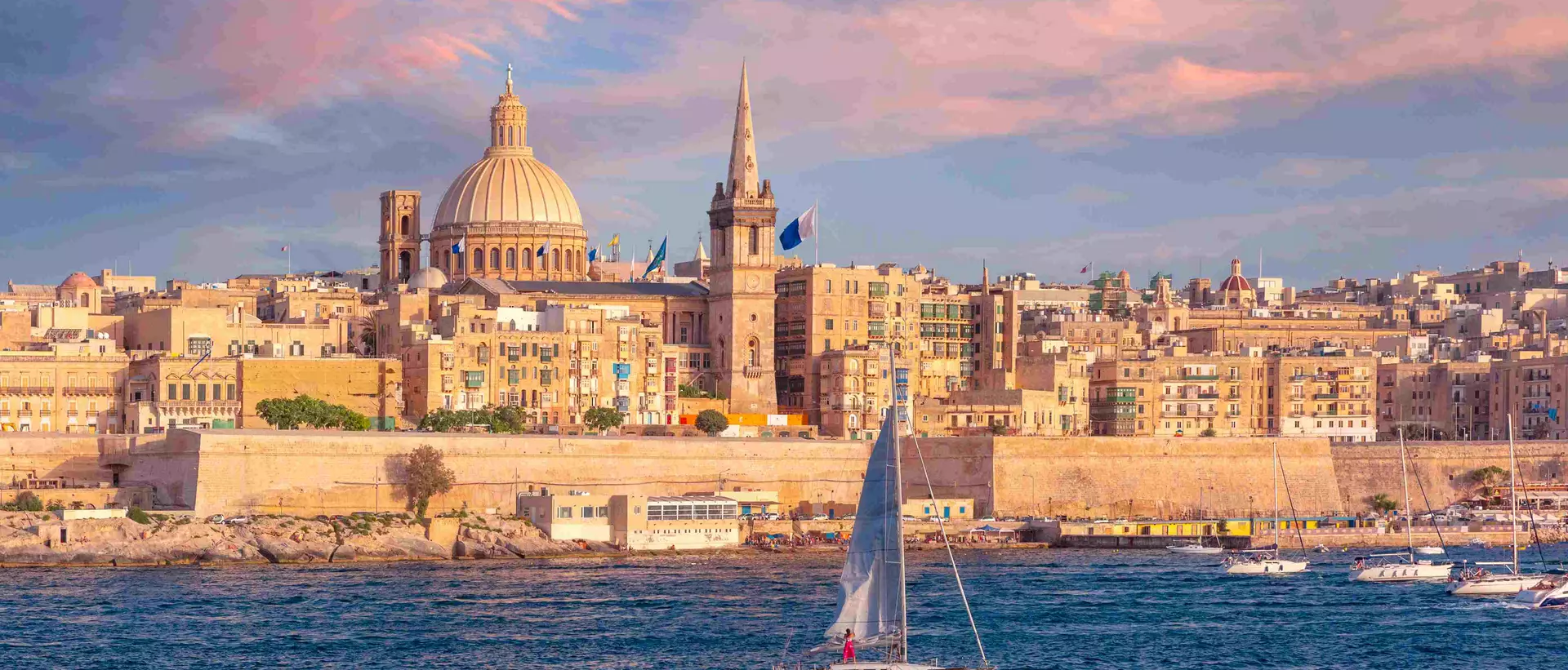 The old town of Valletta with churches of Our Lady of Mount Carmel and St. Paul's Anglican Pro-Cathedral at sunset, Valletta, Malta.