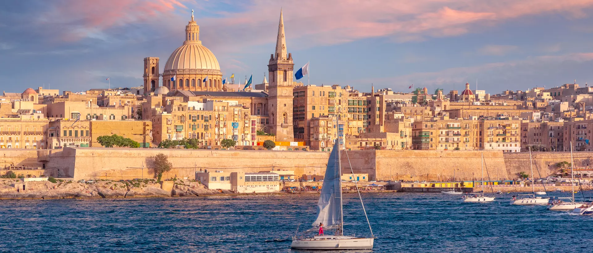 The old town of Valletta with churches of Our Lady of Mount Carmel and St. Paul's Anglican Pro-Cathedral at sunset, Valletta, Malta.