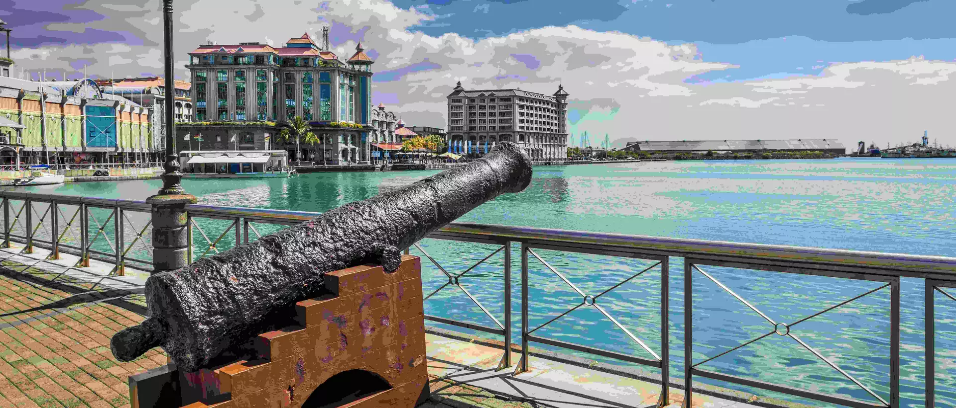Old cannon on the promenade at Caudan Waterfront, Port Louis, Mauritius.