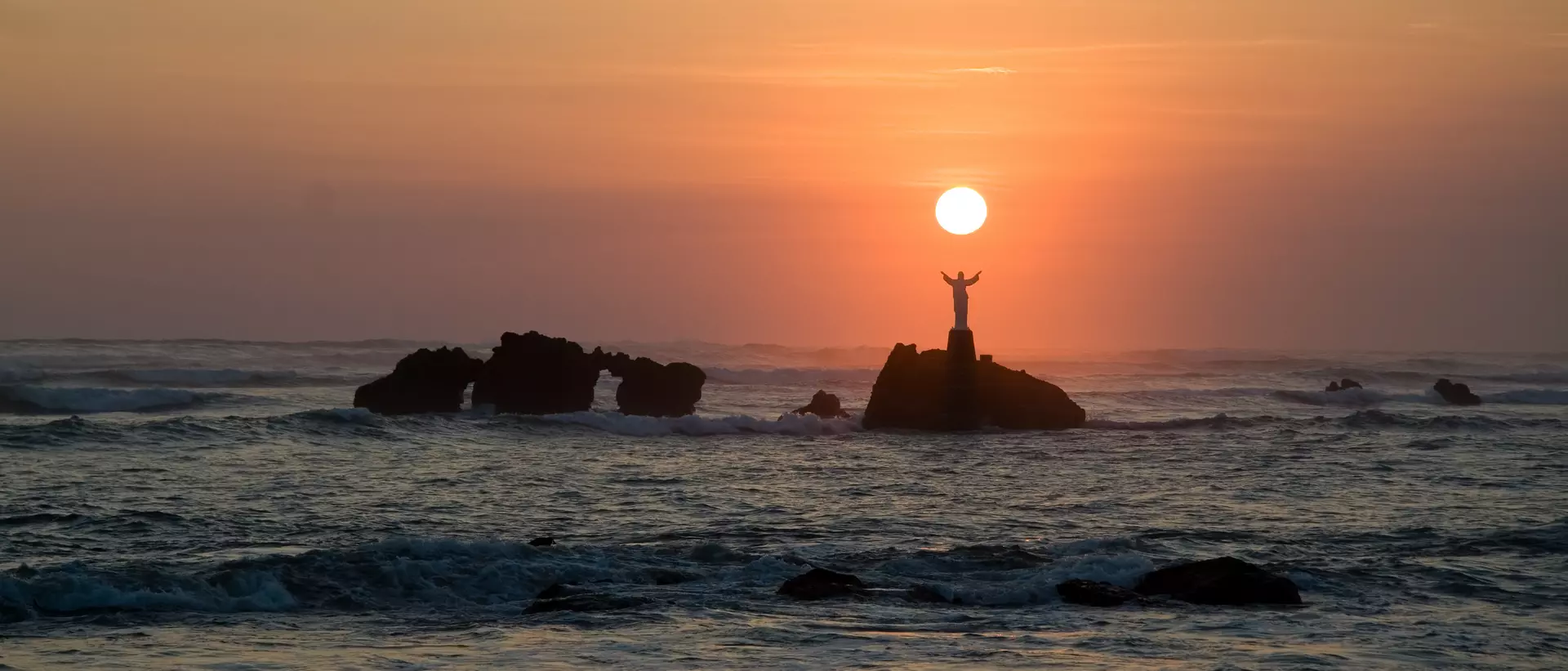 The sun sets over the ocean in El Salvador.