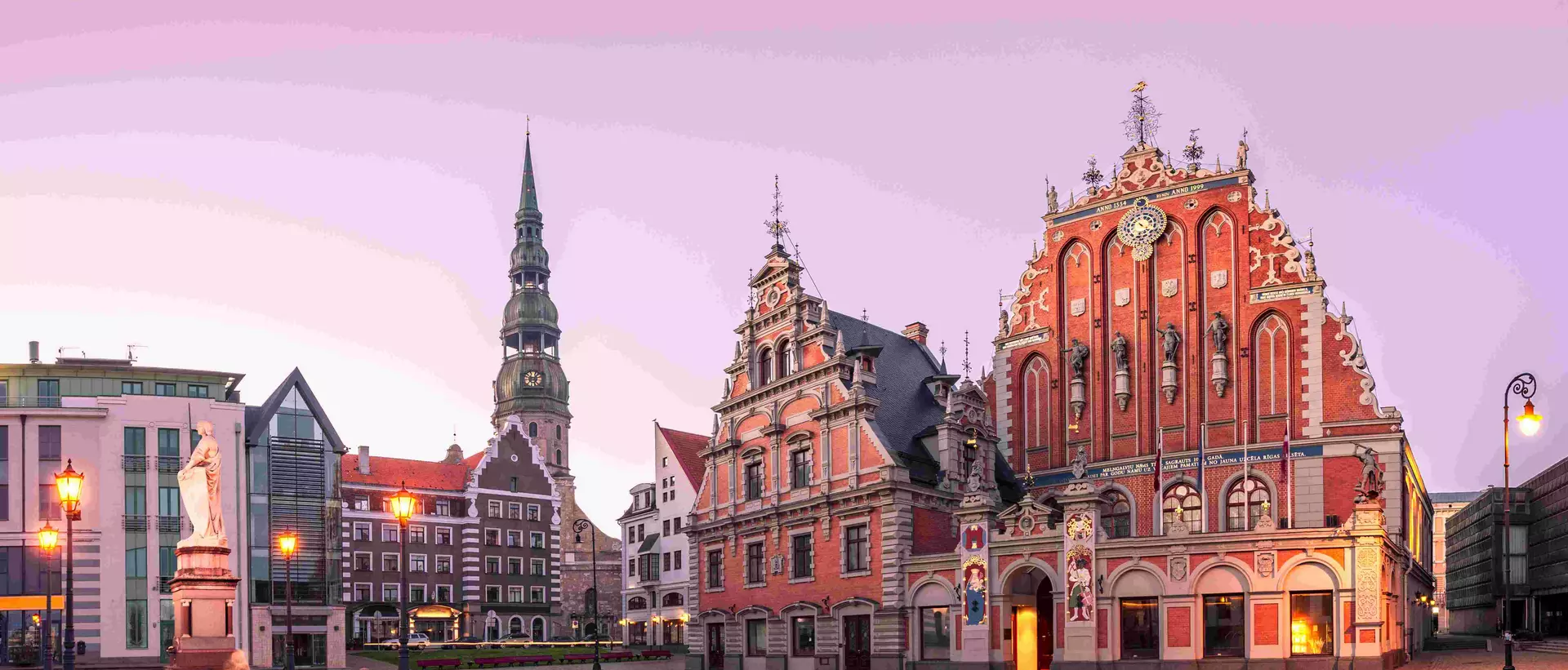 City Hall Square with House of the Blackheads and Saint Peter church in Riga Old Town During sunset time.