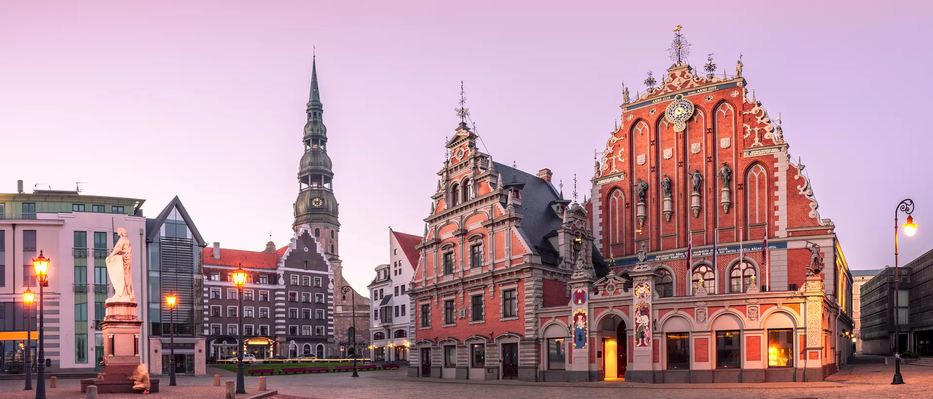 City Hall Square with House of the Blackheads and Saint Peter church in Riga Old Town During sunset time.