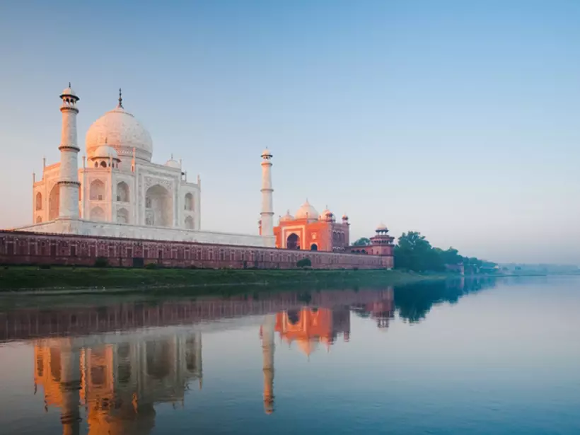 A beautiful sunrise lights the side of the Taj Mahal