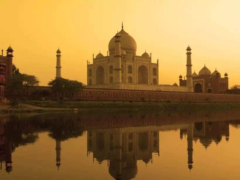 Taj Mahal at sunset reflected in the calm Yamuna River