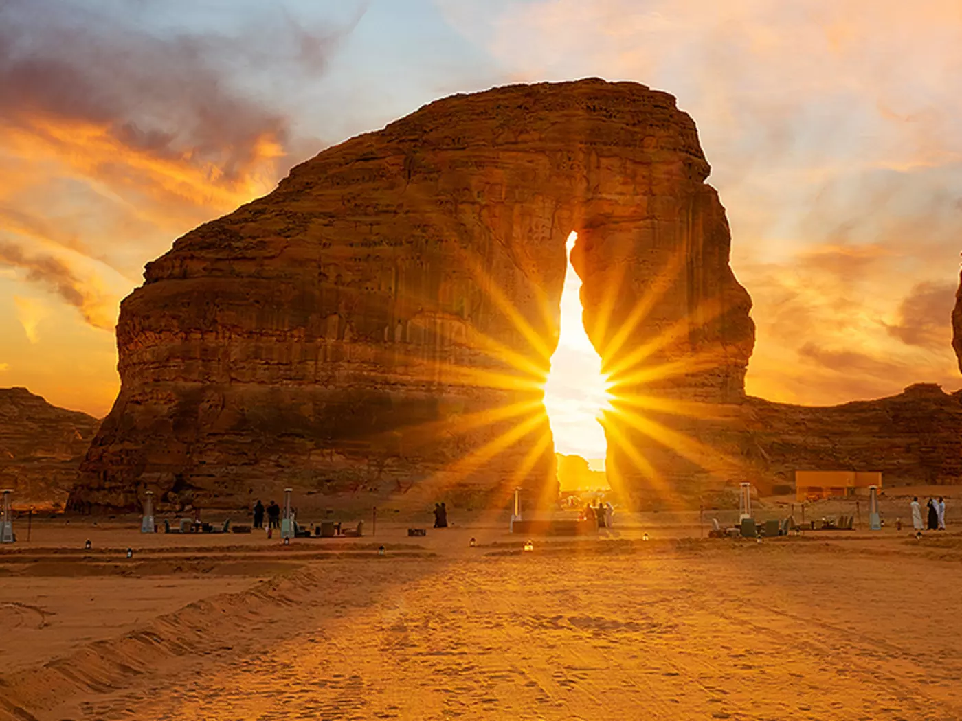 A rock shaped like an elephant at sunset.