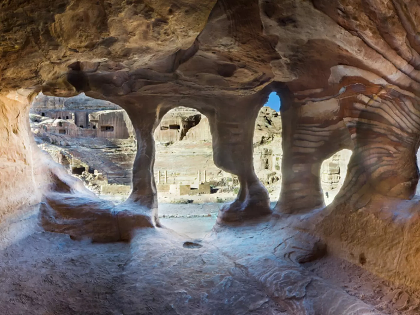 Explore the ancient town of Petra, with intricate caves carved from the surrounding rock