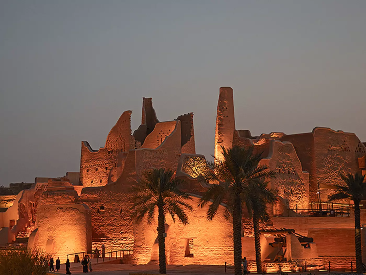 old sandstone fortress at nighttime lit up by floodlights