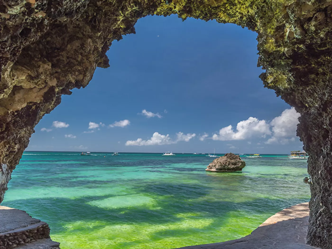 Explore the caves along White Beach, a popular spot in Boracay for its crystal waters and light sands