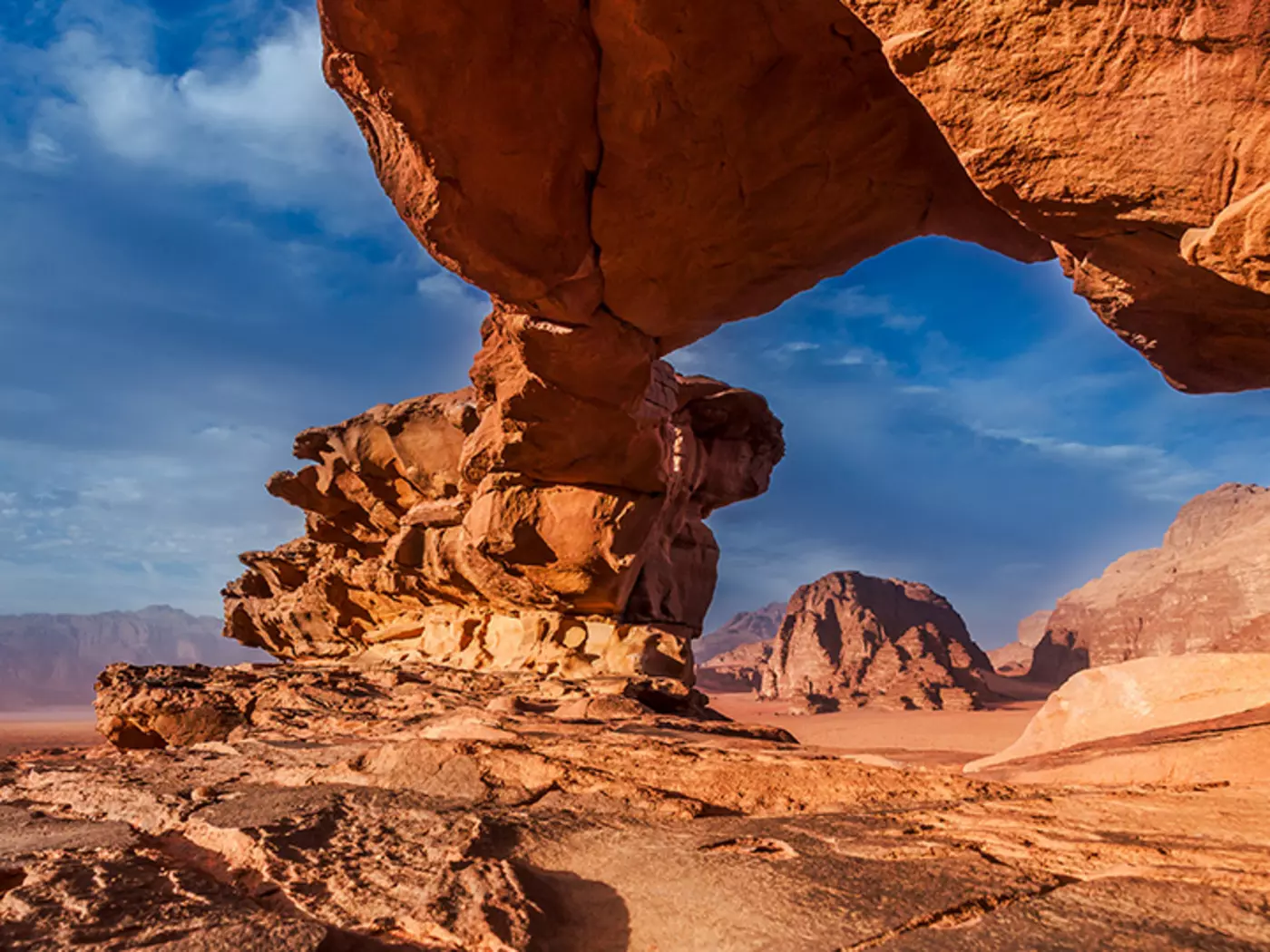 Journey through the Wadi Rum desert with its rock bridges, canyons, and stunning sand dunes
