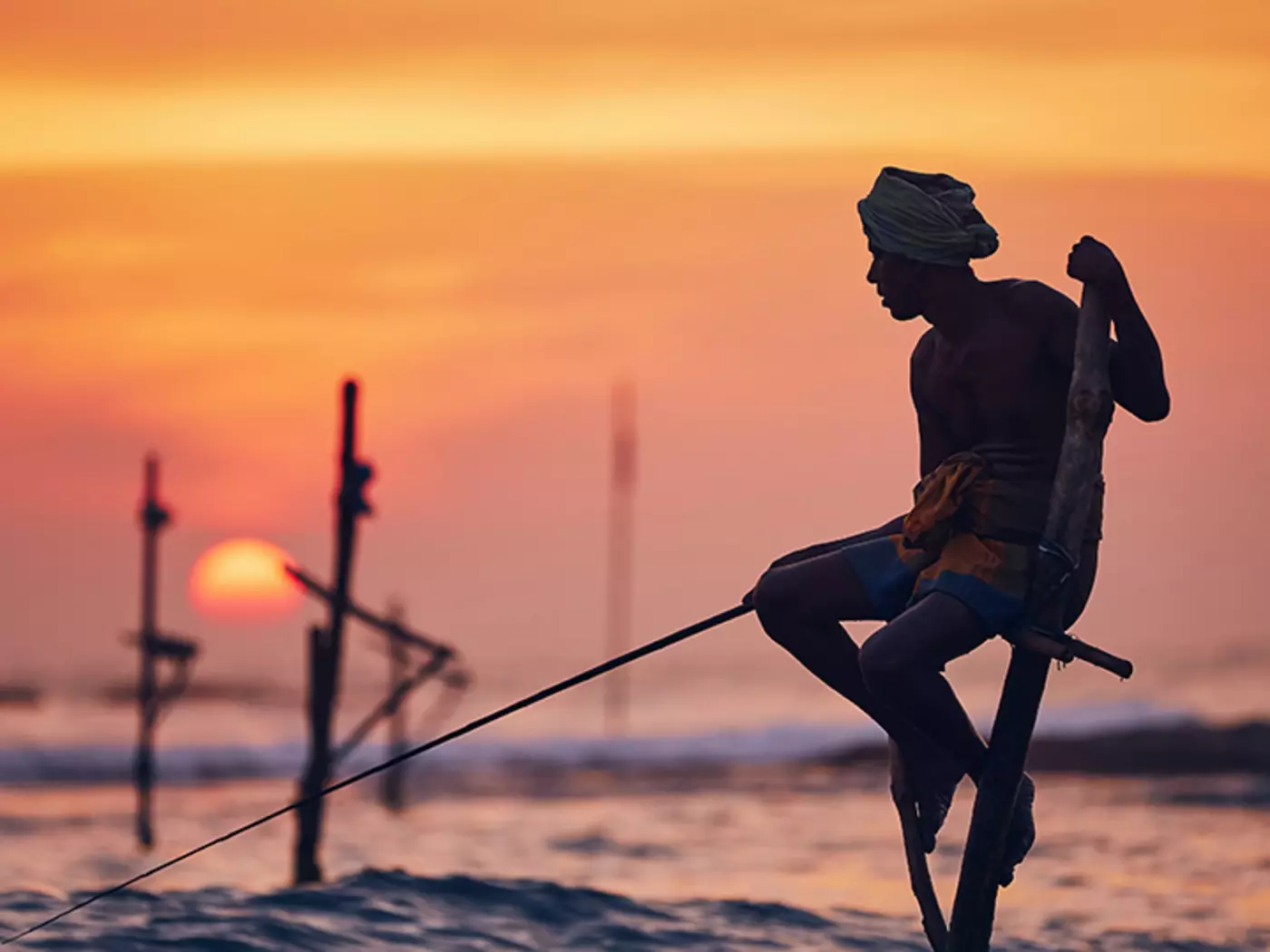 Witness the balancing act of Stilt Fishing from the shores of Galle