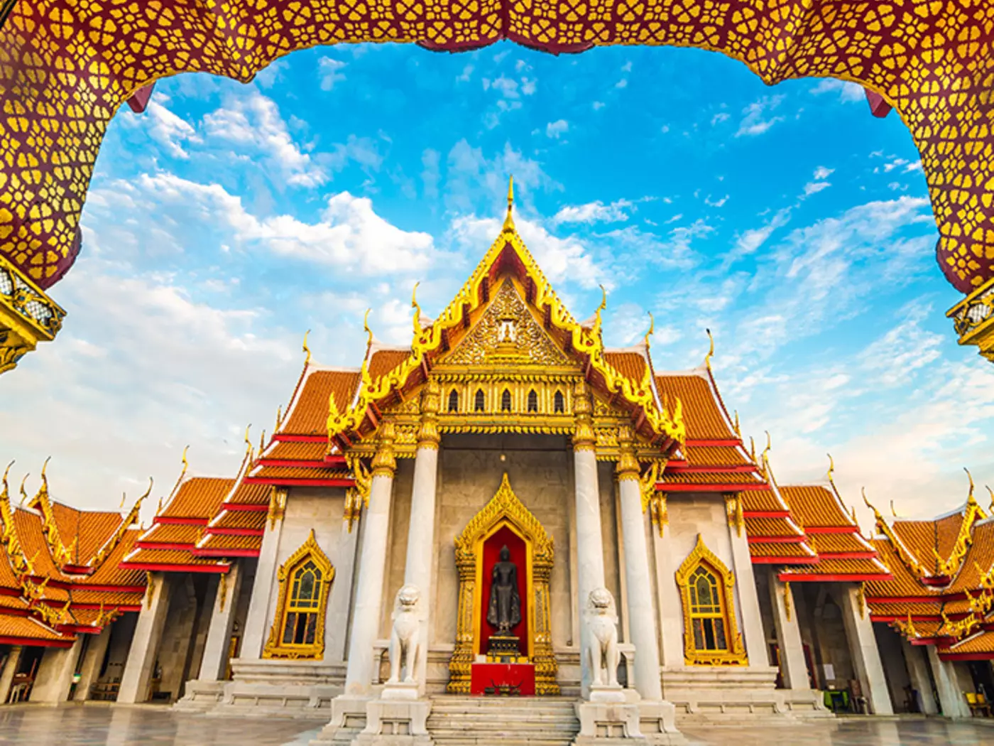 Enter the golden doors of the Wat Benchamabophit temple, better known as Bangkok's Marble Temple