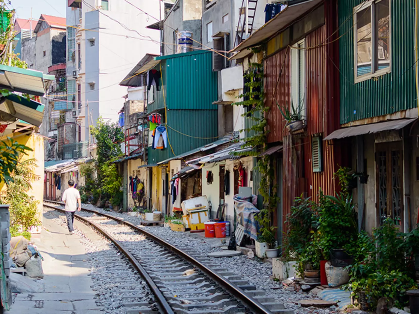 Witness close quarters in the Old Quarter of Hanoi, featuring a community built tightly around running train tracks