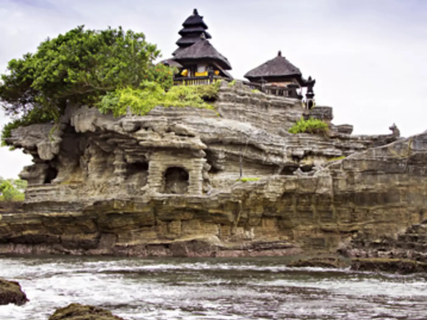 Embrace your spiritual side at Tanah Lot, a rock formation surrounded by the sea that hosts a Hindu temple