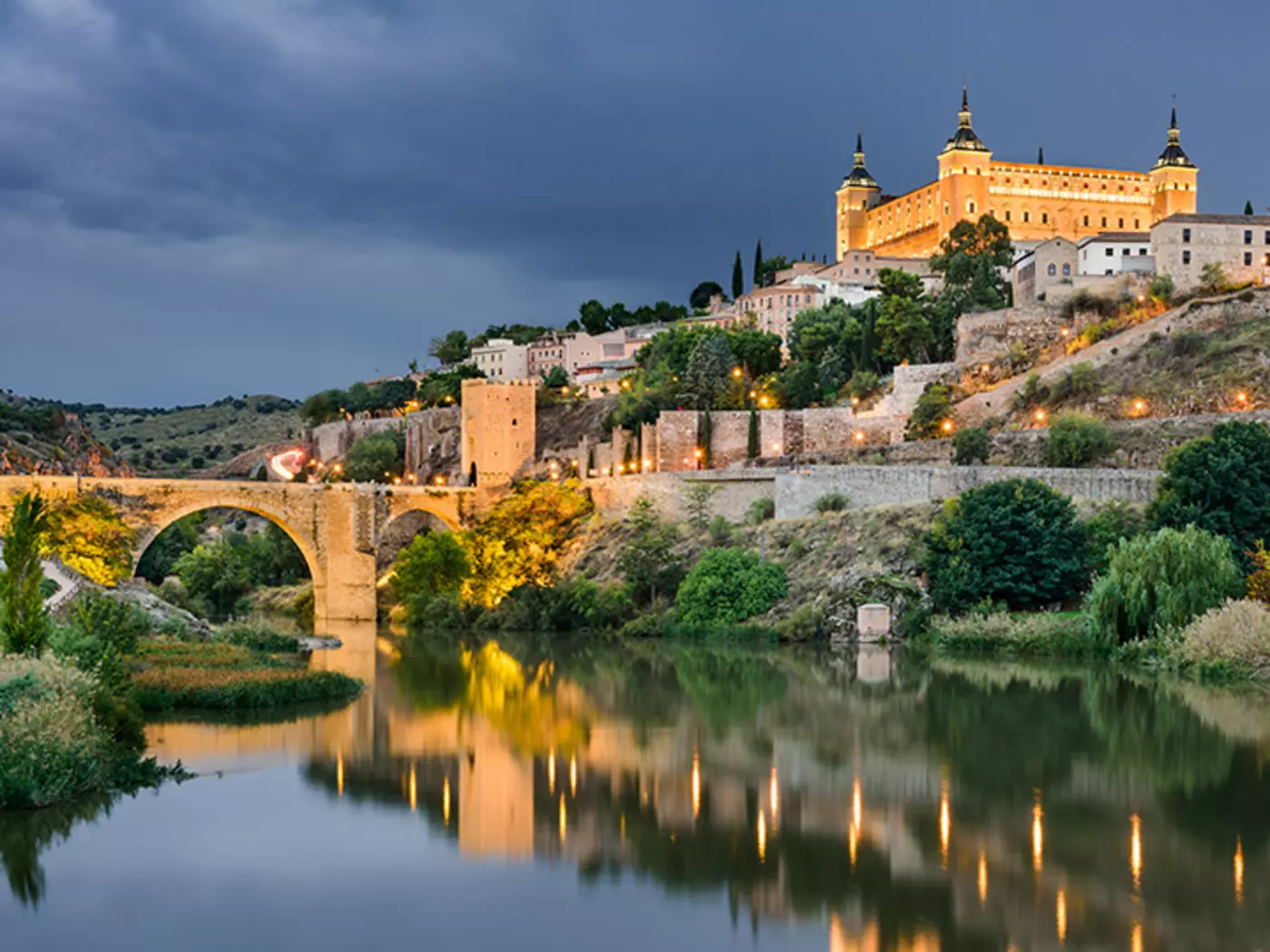 Panorama of the Alcazar in Toledo Panorama of the Alcazar above the medieval San Martin bridge - Toledo, Spain