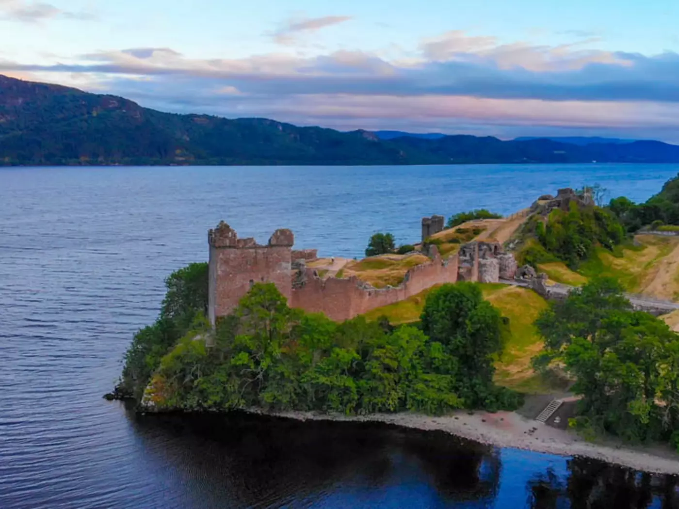 The ruins of Urquhart Castle sit on the shores of Loch Ness