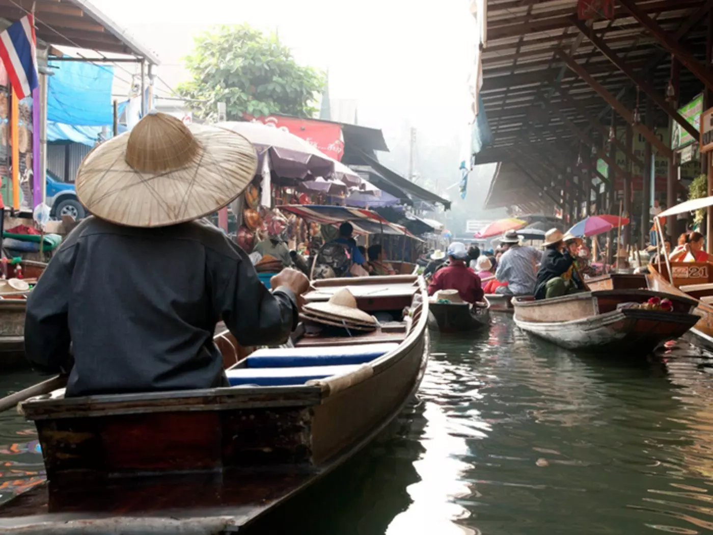 Wooden boats ferrying people at Amphawa floating market