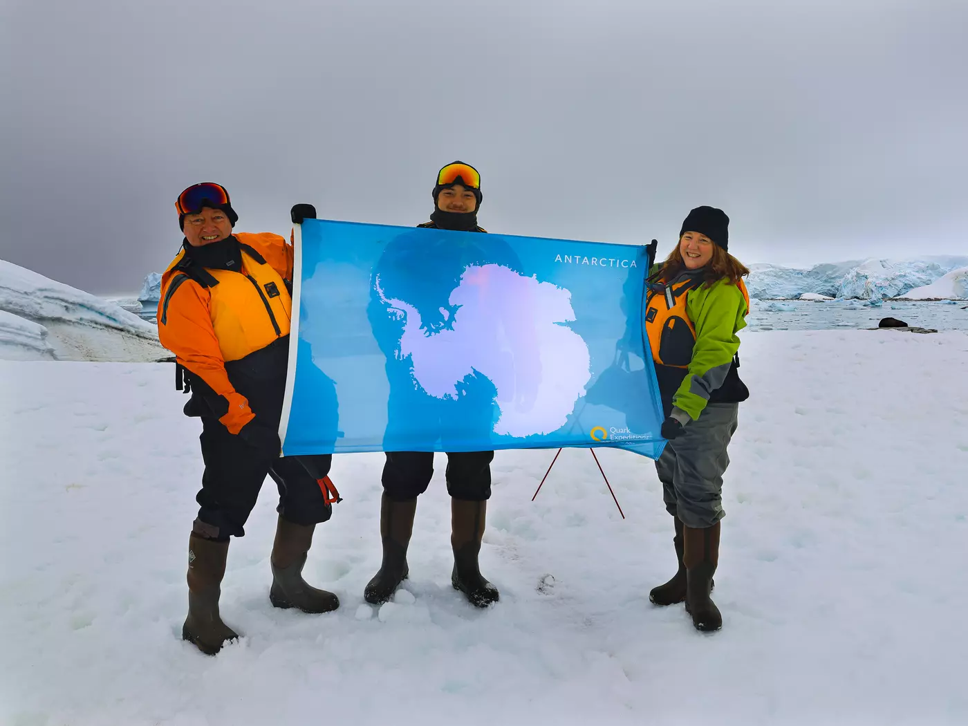 Family Holding the Antarctica Flag on Antarctica