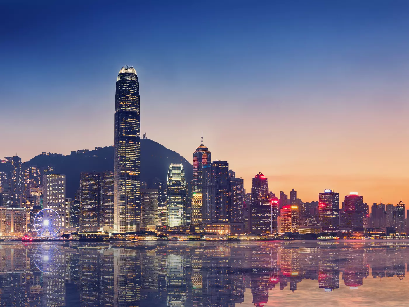 Admire the colours of a Victoria Harbour sunset in Hong Kong