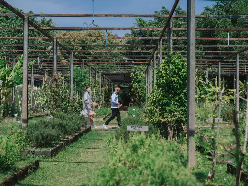People walk through the farm at Jampa Phuket Pru in Thailand