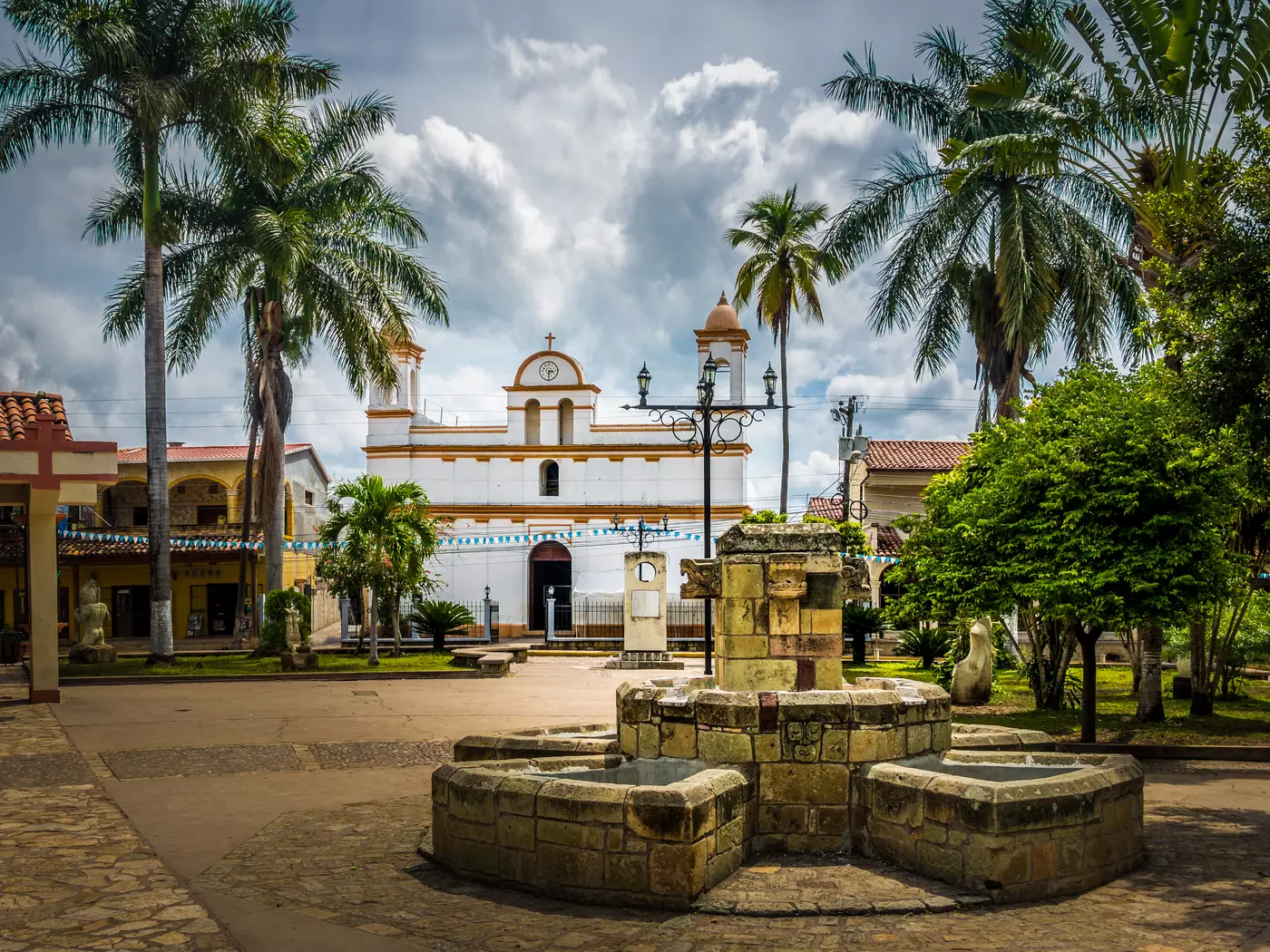 view of a church and fountain in the central square of Copan Ruinas City in Honduras