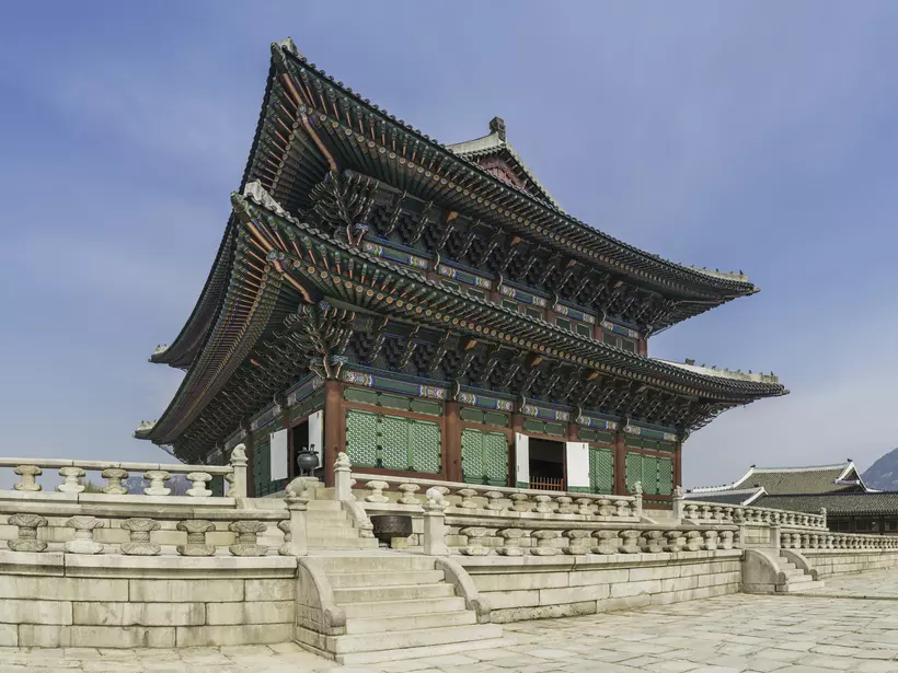 The ornately painted eaves and traditional wooden screens of Geunjeongjeon