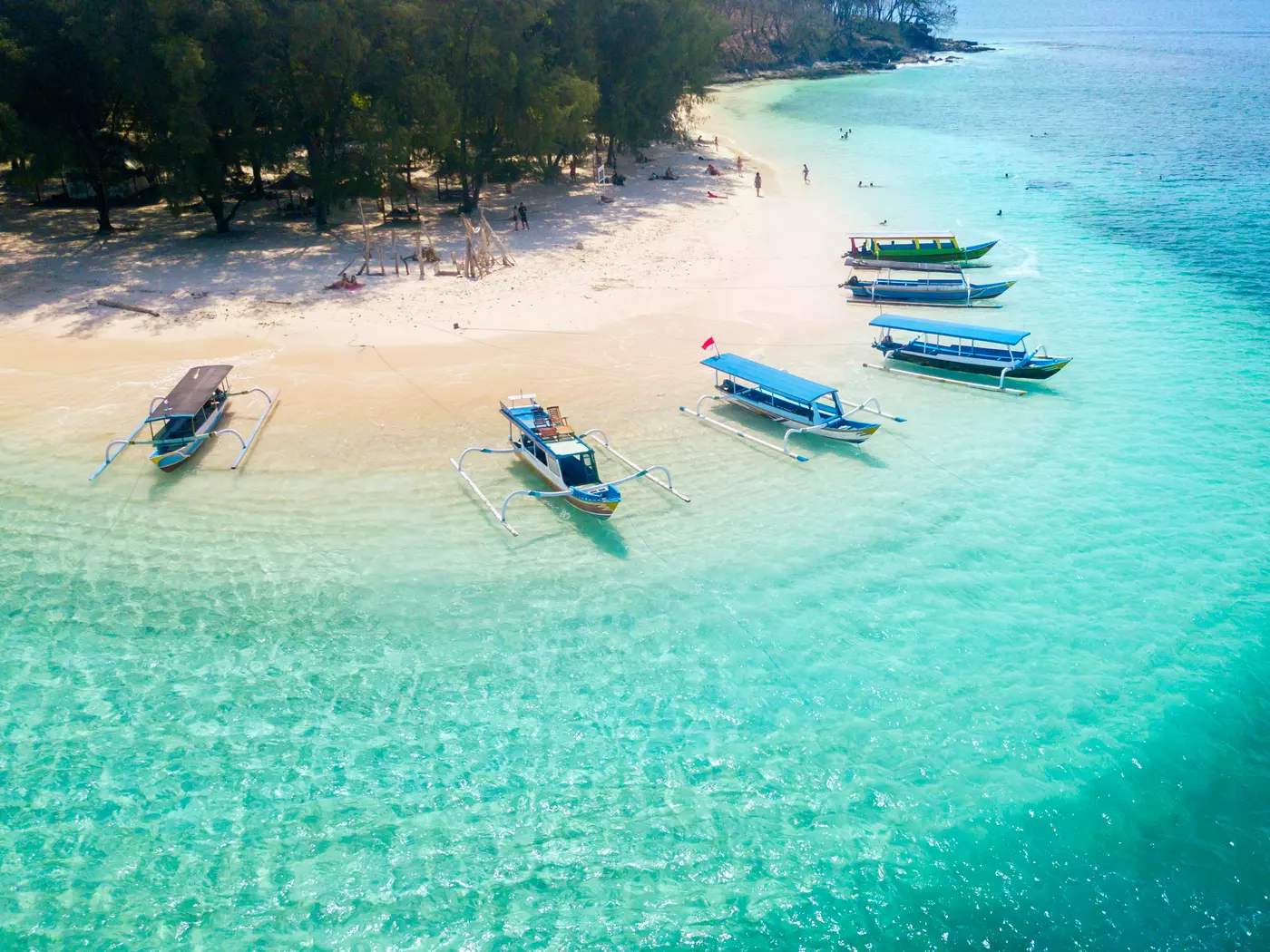 Wooden boats anchored on the Gili Rengit beach