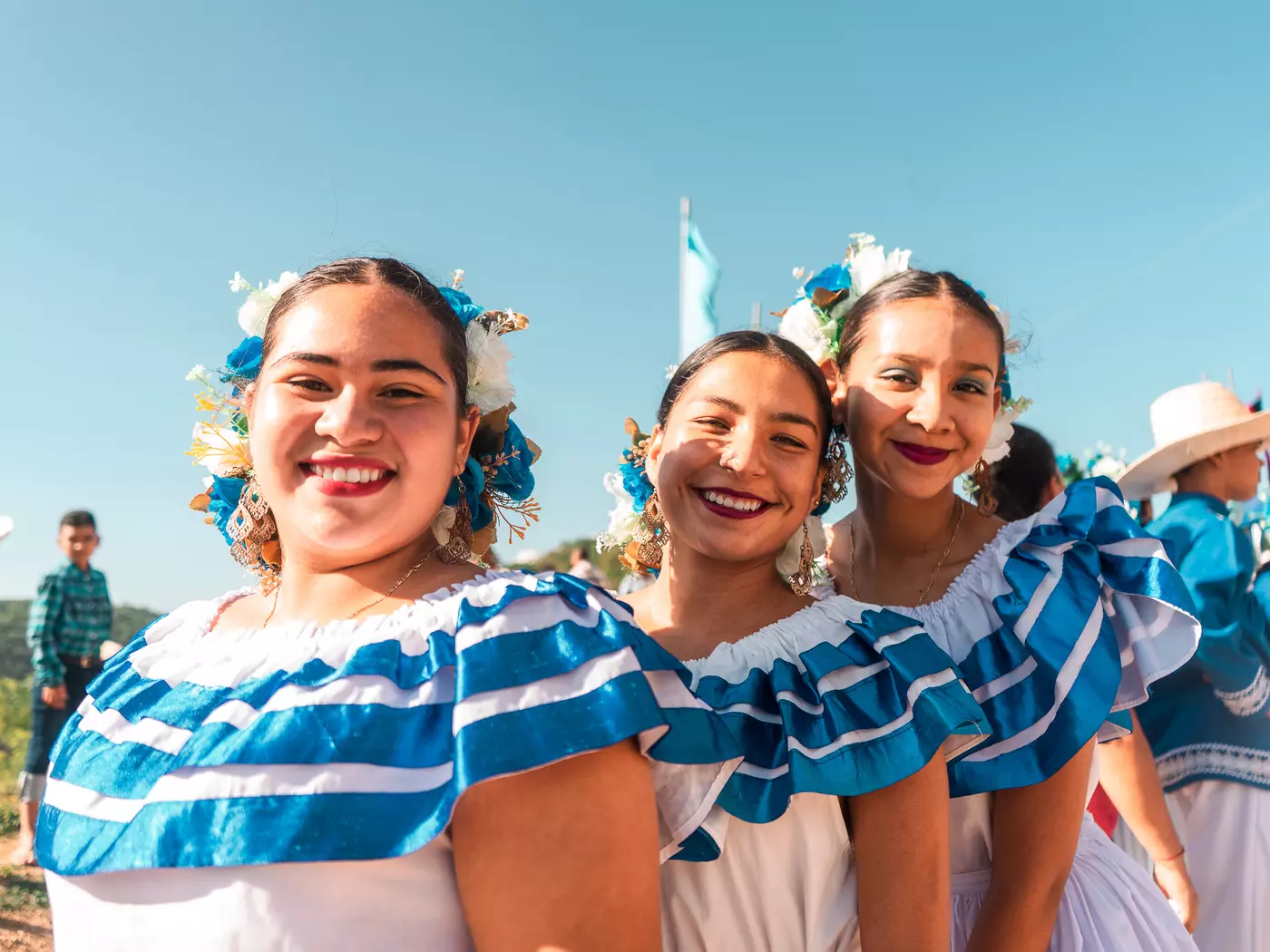 three girls wearing traditional blue dresses in the rural districts of Nicaragua