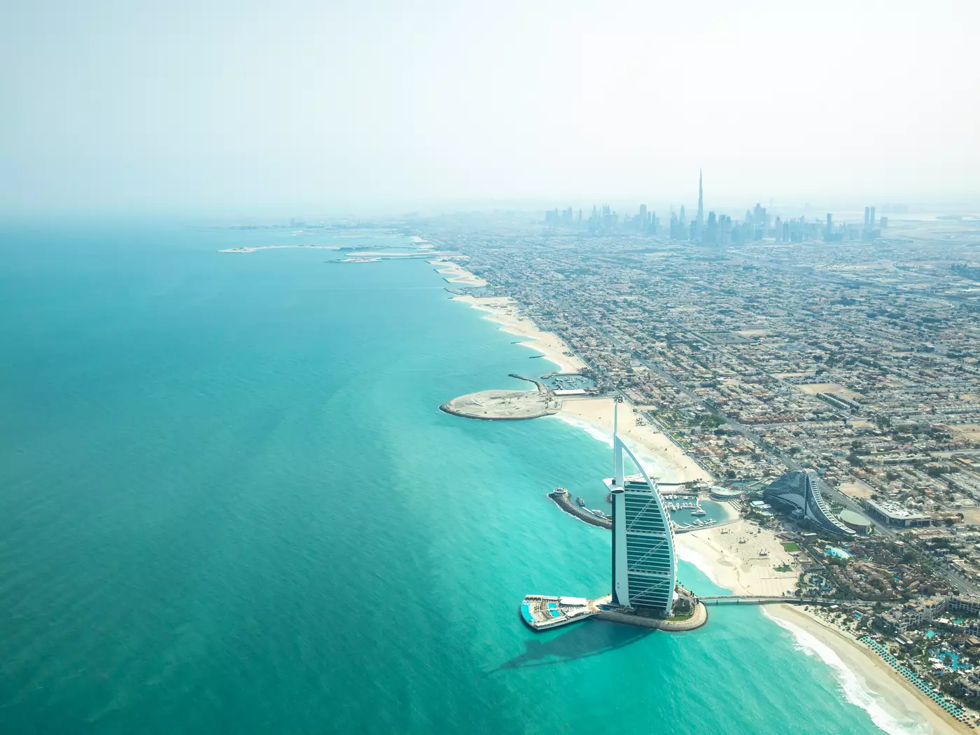 An aerial view of the Burj Al Arab and the skyline of Dubai.