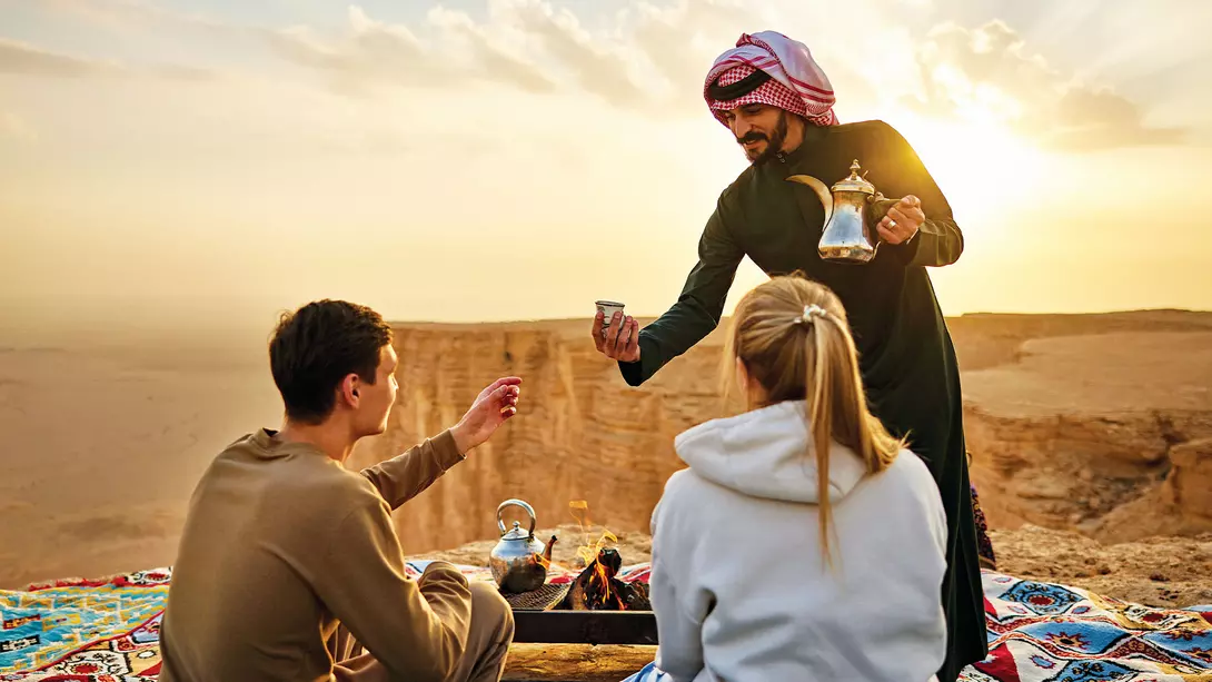 The Edge of the World, Saudi Arabia A Saudi guide serves traditional tea to western travellers at the Edge of the World in Riyadh, Saudi Arabia