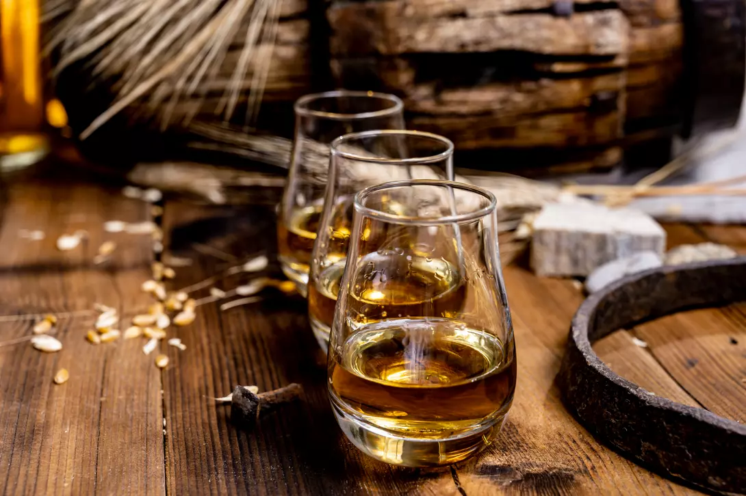 glasses of scotch on a wooden table