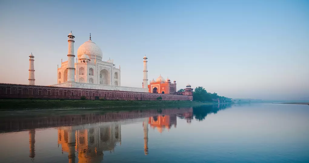 A beautiful sunrise lights the side of the Taj Mahal A beautiful sunrise lights the side of the Taj Mahal