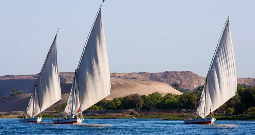 Feluccas sailing on the Nile are a great photo opportunity while on Aswan tours. Feluccas sailing on the Nile are a great photo opportunity while on Aswan tours.