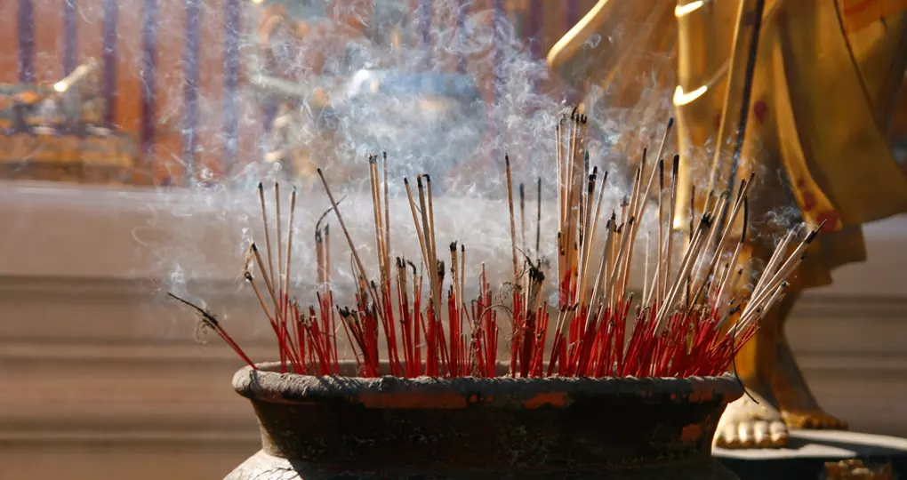 Burning incense sticks at a Buddhist temple Burning incense sticks at a Buddhist temple