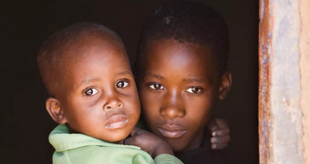 Small children looking out the window.