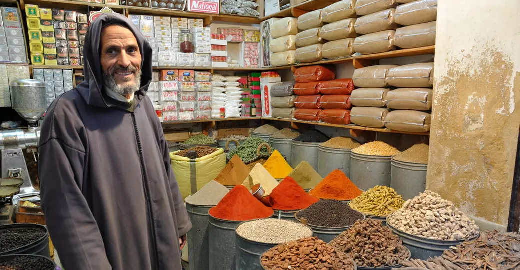 A spice seller in the medina of Fez makes for a great photo opportunity on all Morocco vacations.