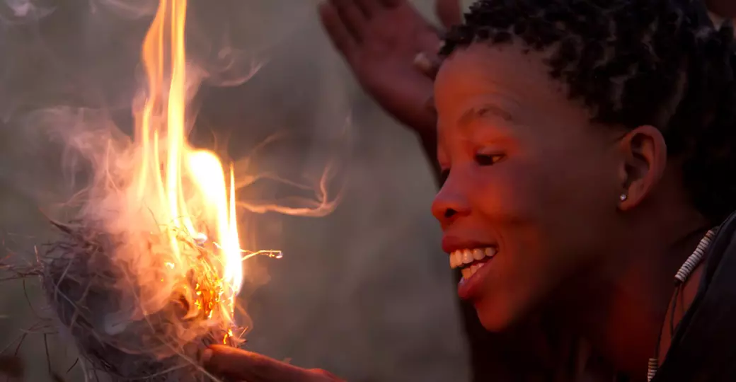 A women making fire as seen while travelling on your Serengeti National Park safari.