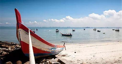 Fishing on the beach under a blue sky