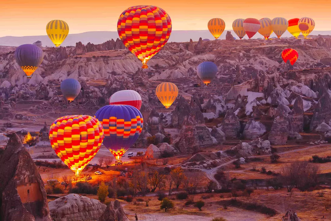 Scenic vibrant view of balloons in flight in Cappadocia Valley