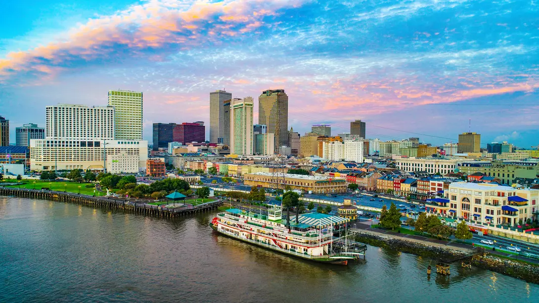 Skyline of city along the Mississippi river, steamboat in foreground
