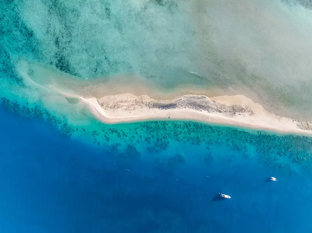 High angle aerial drone view of the sandbar and blue waters