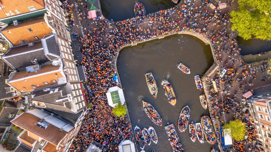 Canal boat parade on Koningsdag Kings day festivities in Amsterdam. Birthday of the king